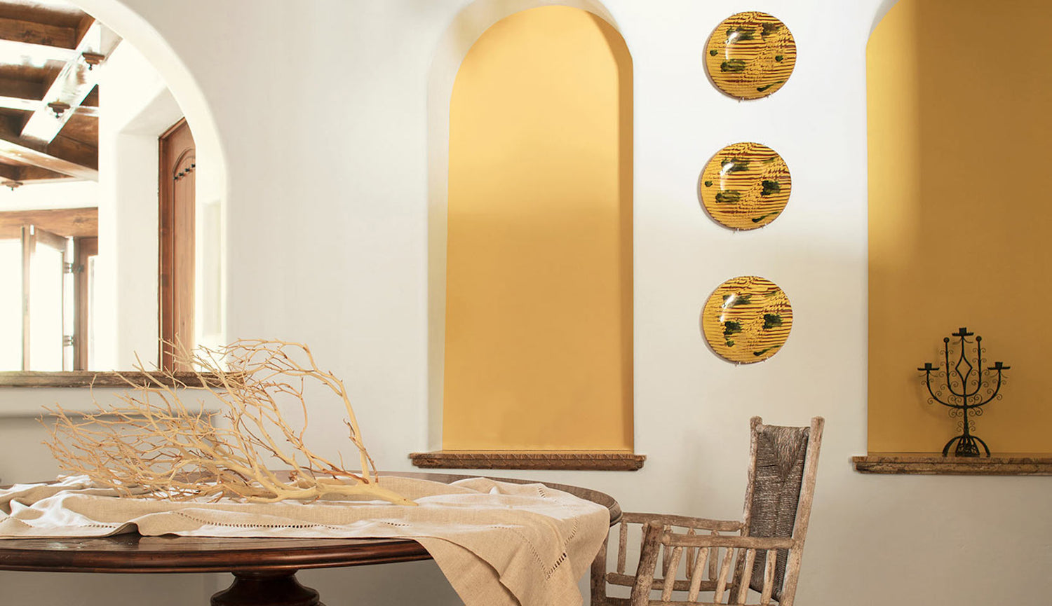 An elegant dining area in yellow wall accents.